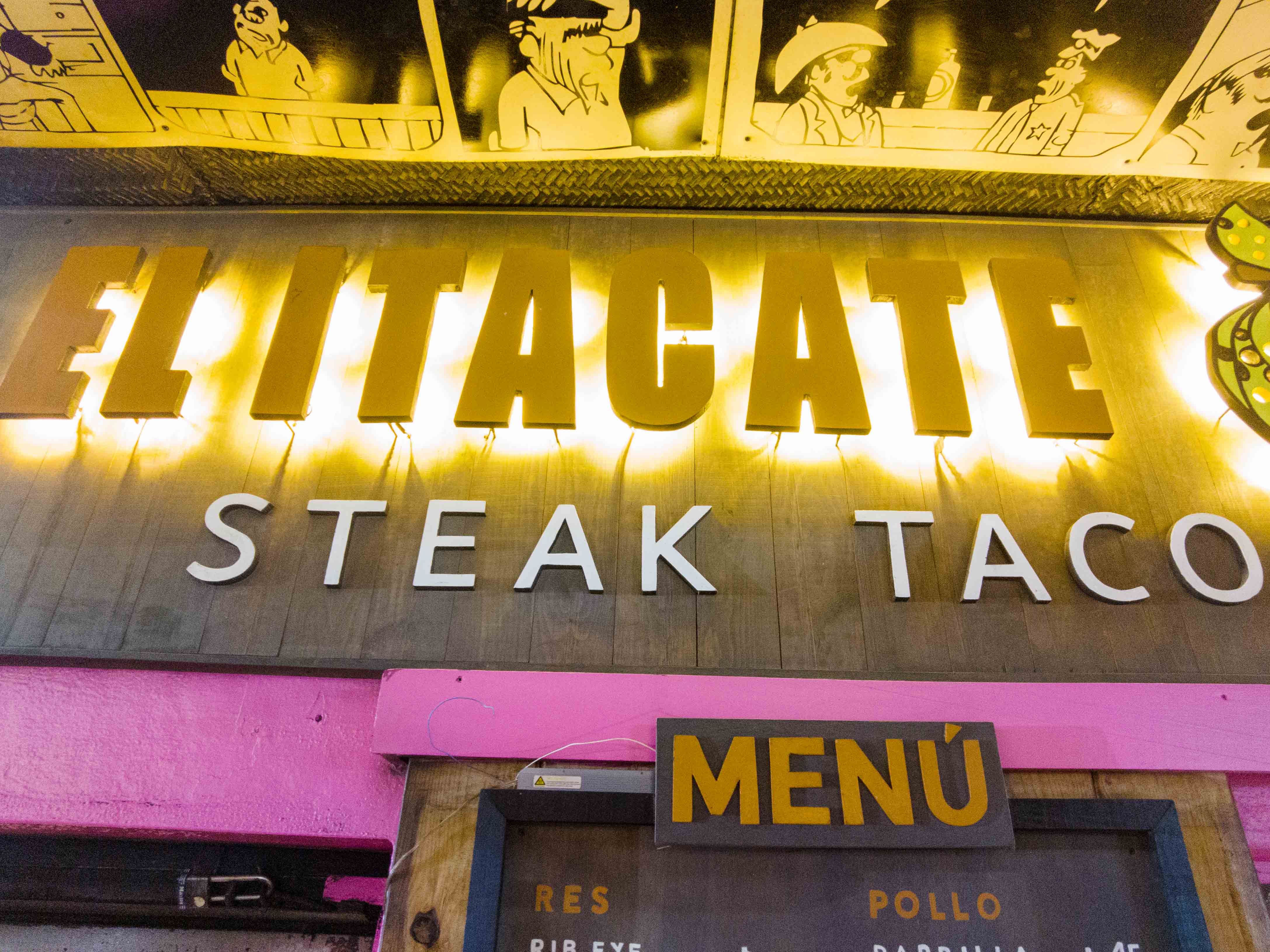 Illuminated sign of Itacate restaurant in Sayulita